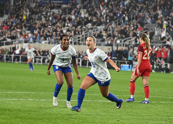Ally Sentnor and Naimi Girma celebrating Sentnor's goal against Canada